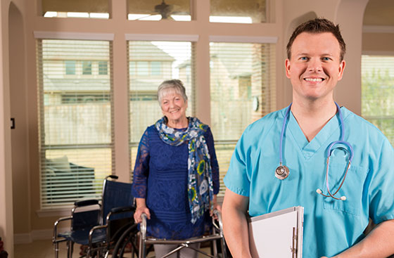 Smiling nurse with patient in the background